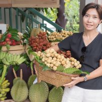 Asian woman with tropical fruit basket